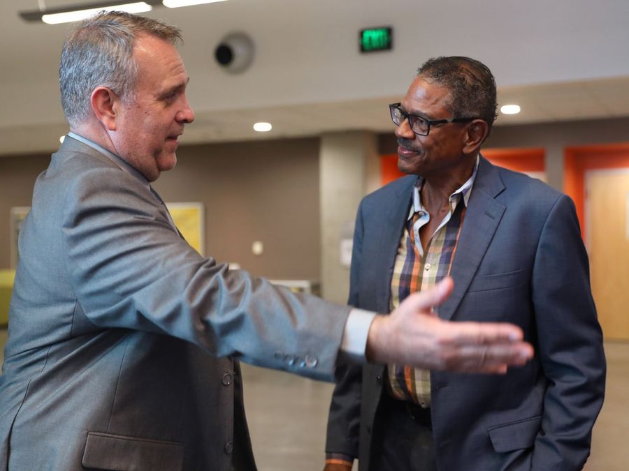 Two attendees greeting each other at an Arizona Talks reception